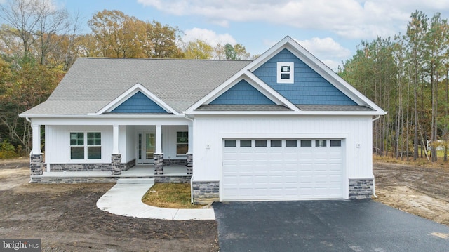 craftsman house featuring covered porch and a garage