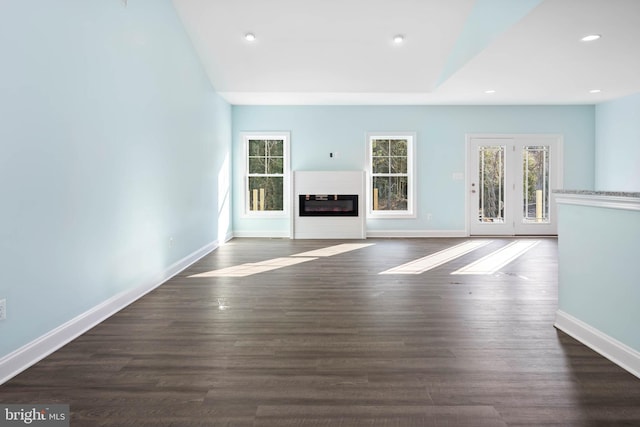 unfurnished living room featuring dark wood-type flooring