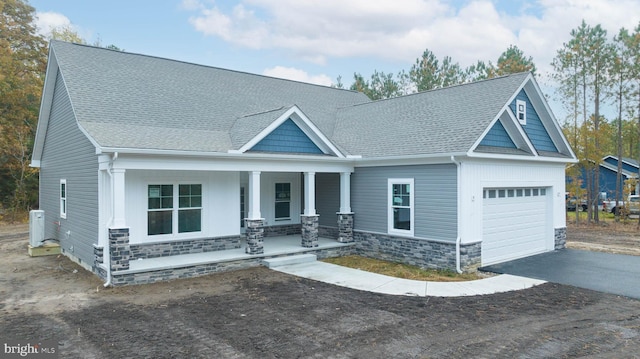 craftsman house featuring covered porch and a garage