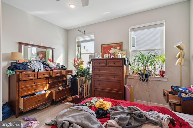 bedroom with ceiling fan and light hardwood / wood-style flooring