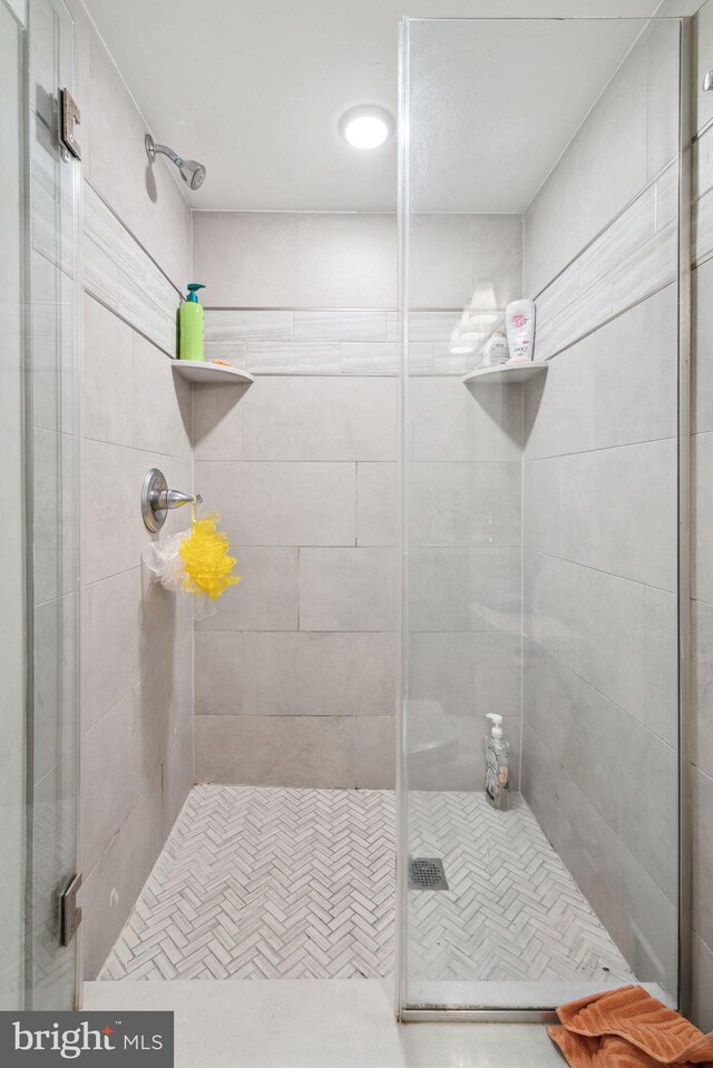 bathroom with a shower with door