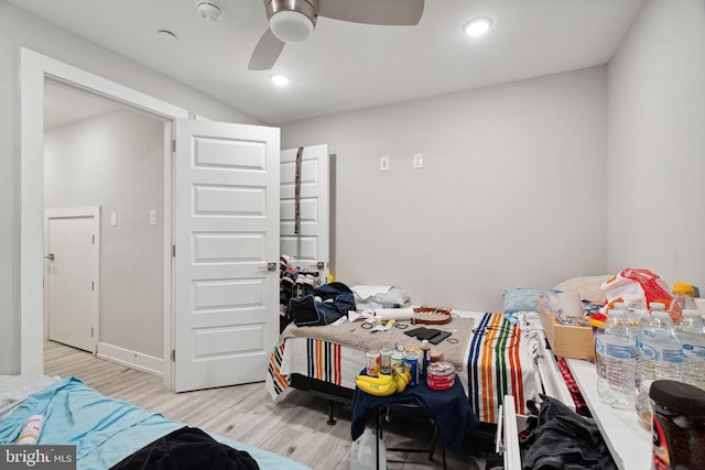 bedroom with ceiling fan and light hardwood / wood-style flooring