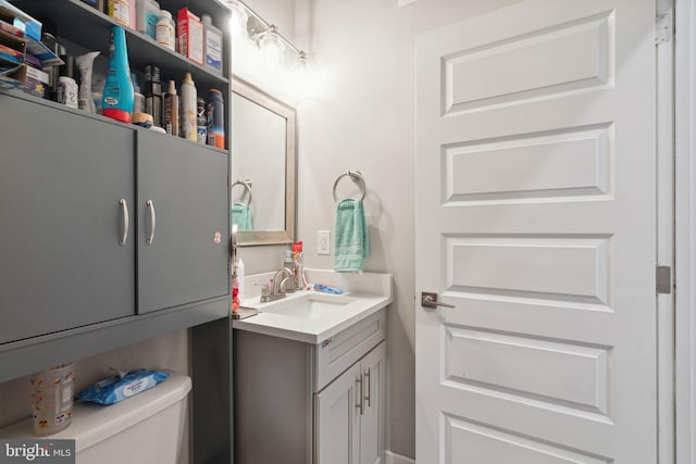 bathroom with toilet and oversized vanity