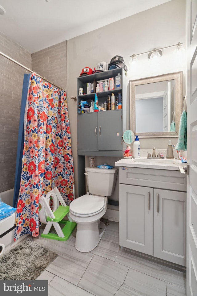 full bathroom featuring toilet, vanity, shower / bathtub combination with curtain, and tile flooring