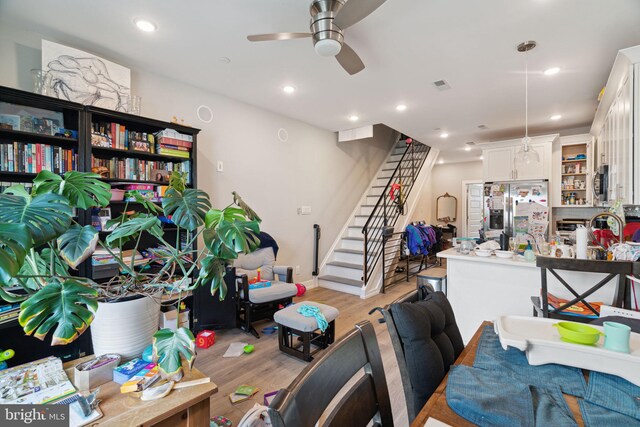 interior space with ceiling fan and light hardwood / wood-style floors