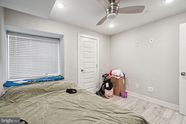 bedroom with ceiling fan, a closet, and light hardwood / wood-style flooring