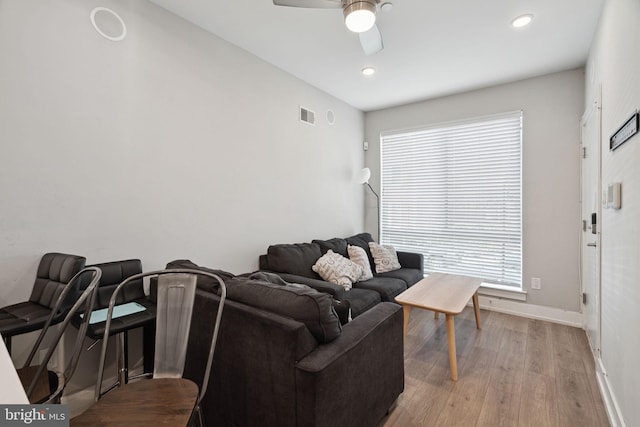 living room featuring ceiling fan and light wood-type flooring