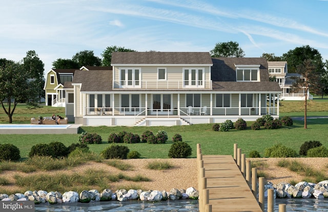 rear view of property featuring covered porch, a sunroom, and a lawn