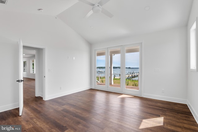 empty room featuring vaulted ceiling, a water view, ceiling fan, and dark hardwood / wood-style floors