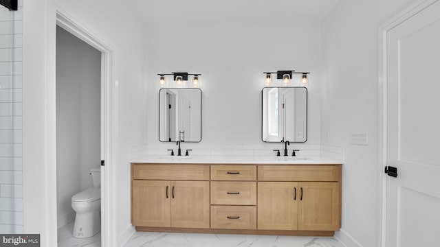 bathroom featuring toilet and vanity