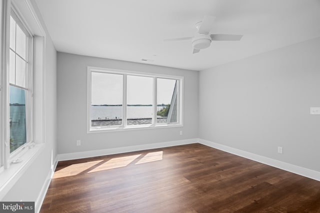 unfurnished room featuring ceiling fan and dark hardwood / wood-style floors