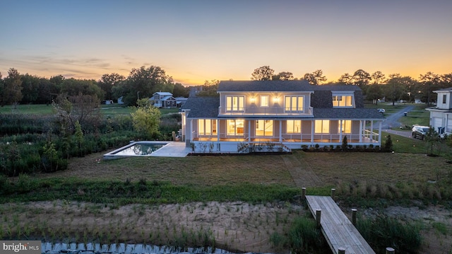 back house at dusk with a jacuzzi