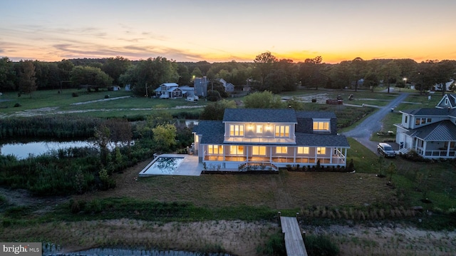 aerial view at dusk with a water view