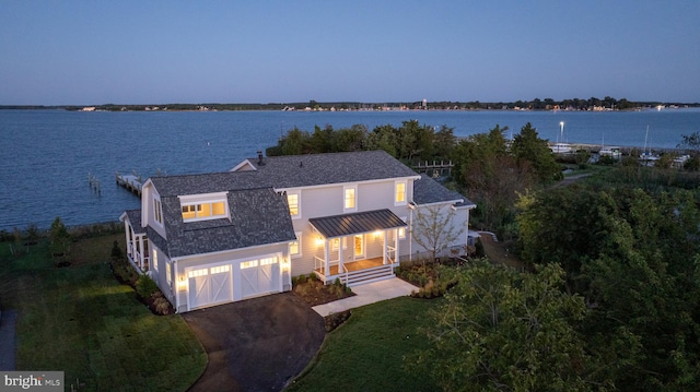 aerial view at dusk with a water view