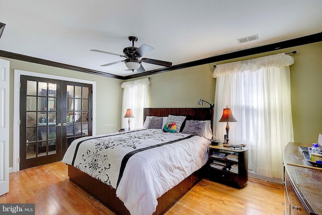 bedroom featuring french doors, crown molding, light hardwood / wood-style flooring, and ceiling fan