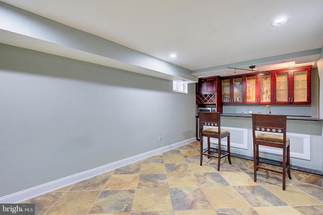 bar featuring light tile floors and sink