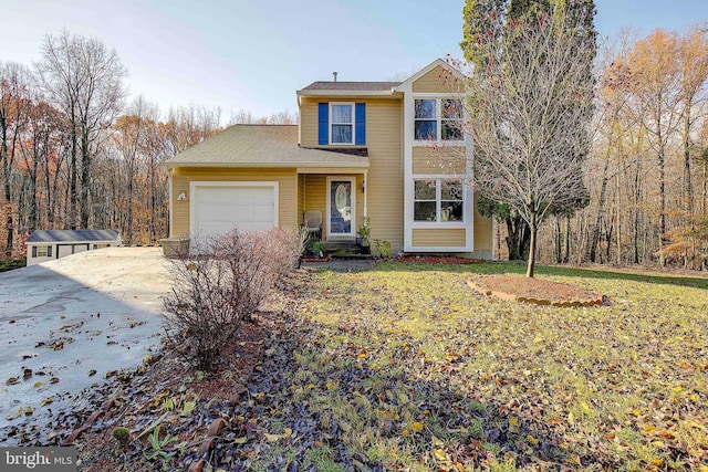 view of front property featuring a front lawn and a garage