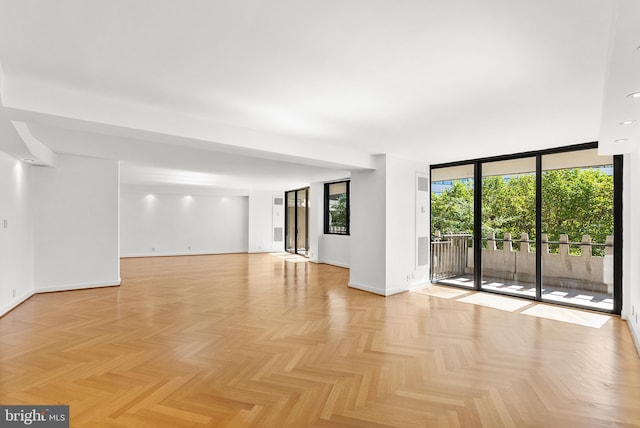 spare room with light parquet floors and floor to ceiling windows