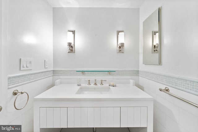 bathroom with tile walls and vanity with extensive cabinet space