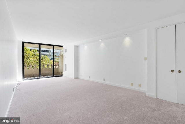 spare room with light colored carpet