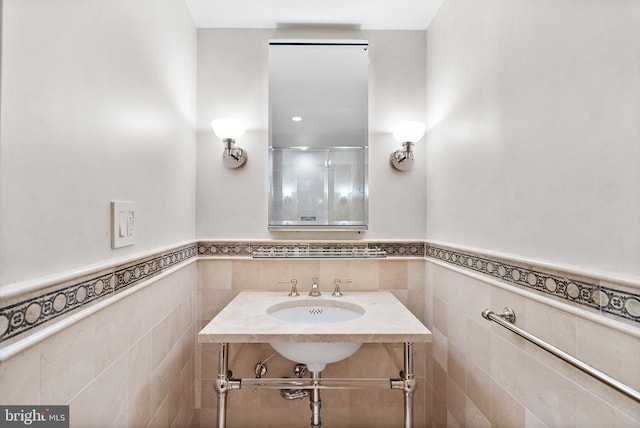 bathroom featuring tile walls, oversized vanity, and tasteful backsplash