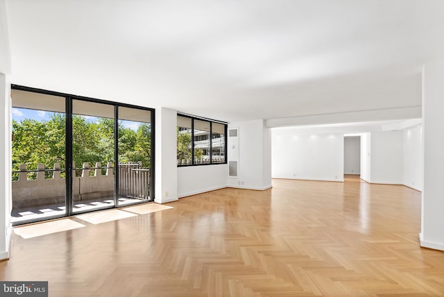 spare room featuring floor to ceiling windows and light parquet floors