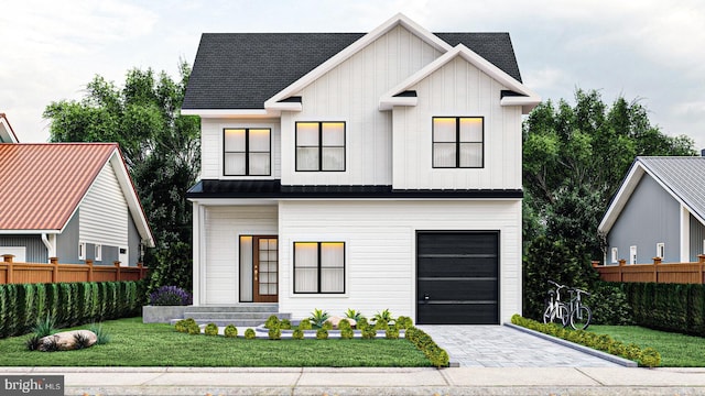 modern inspired farmhouse with a front yard and a garage