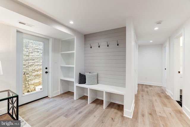 mudroom with recessed lighting, wood walls, visible vents, baseboards, and light wood-type flooring