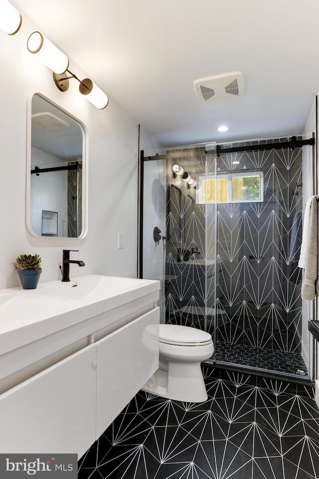 full bathroom featuring tile patterned flooring, toilet, visible vents, vanity, and a shower stall