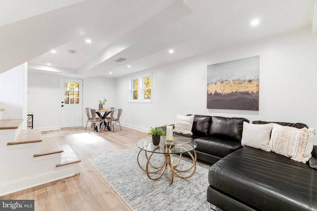 living area with light wood-type flooring, visible vents, baseboards, and recessed lighting