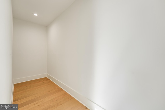 interior space featuring recessed lighting, wood finished floors, and baseboards