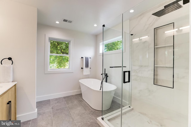 bathroom with a stall shower, vanity, visible vents, and baseboards