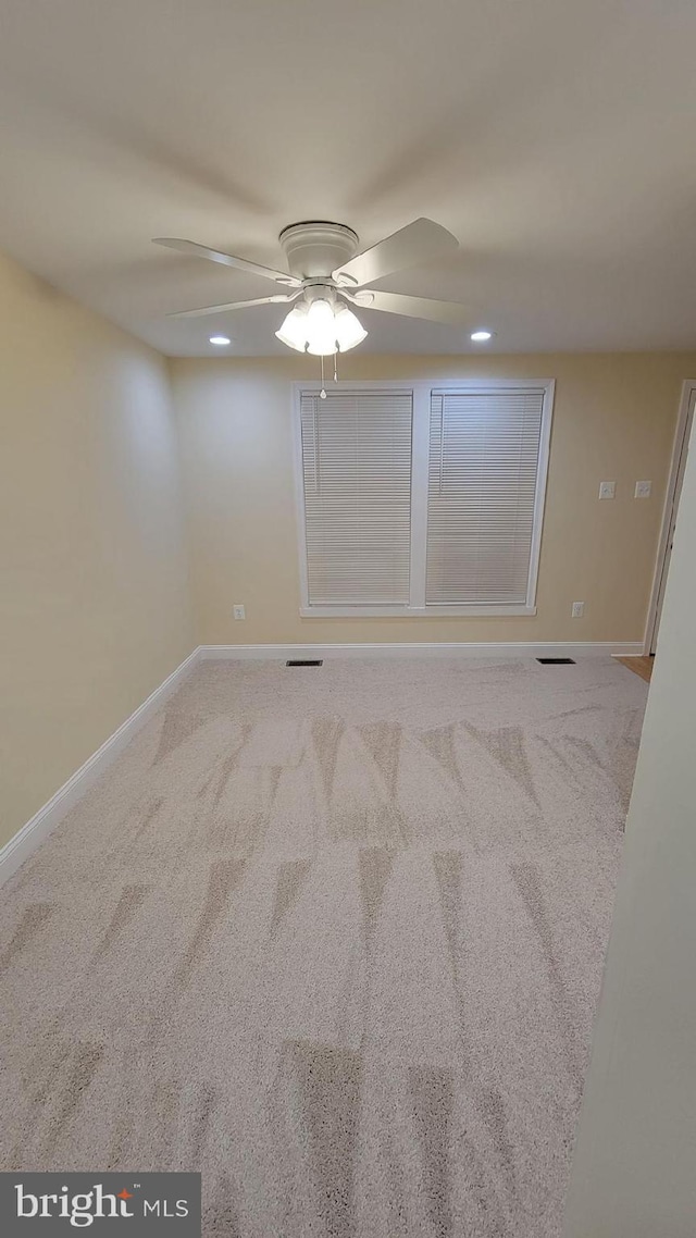 spare room featuring carpet flooring and ceiling fan