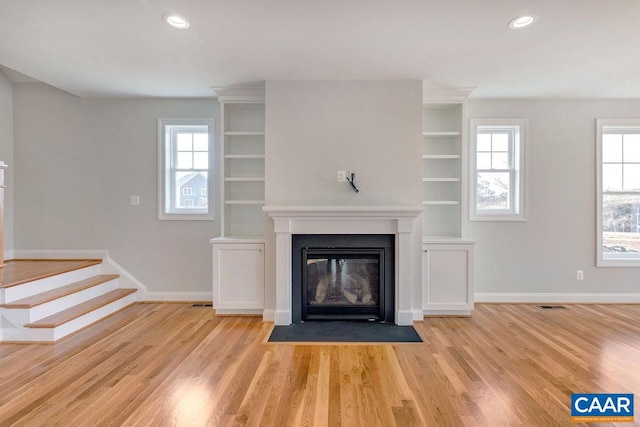 unfurnished living room featuring light hardwood / wood-style flooring