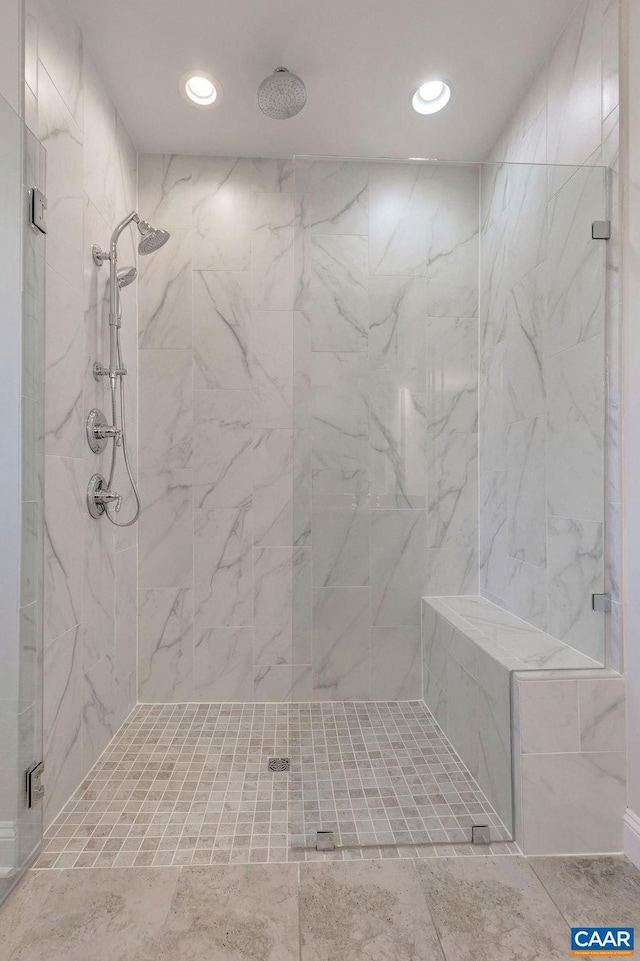 bathroom featuring tile floors and tiled shower