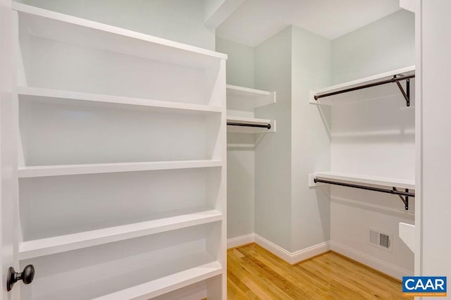 walk in closet featuring light hardwood / wood-style flooring