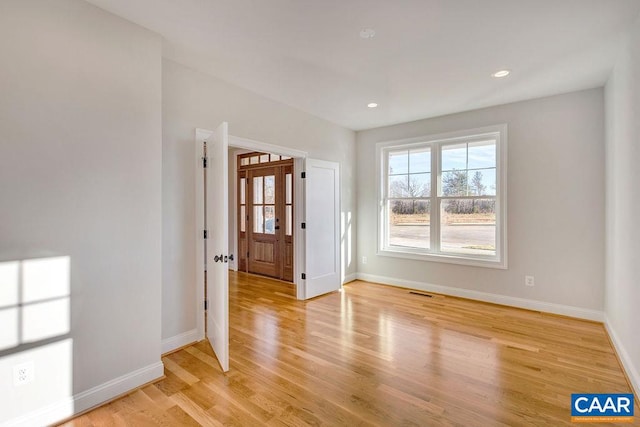 spare room featuring light hardwood / wood-style flooring