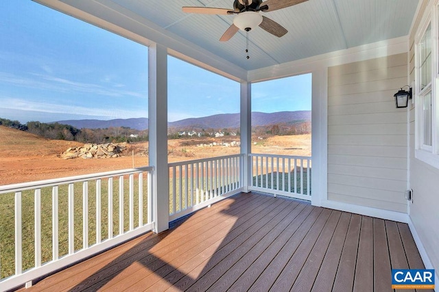 deck with ceiling fan and a mountain view