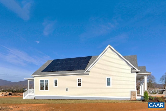 view of property exterior with solar panels