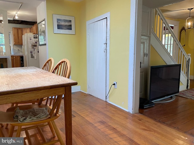 dining room with track lighting and light hardwood / wood-style floors