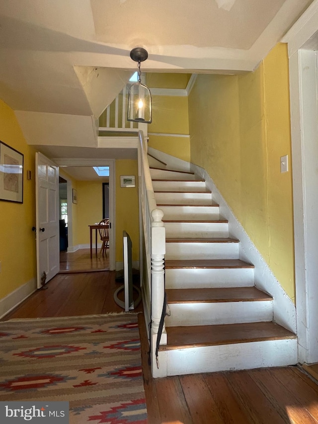 staircase with dark wood-type flooring