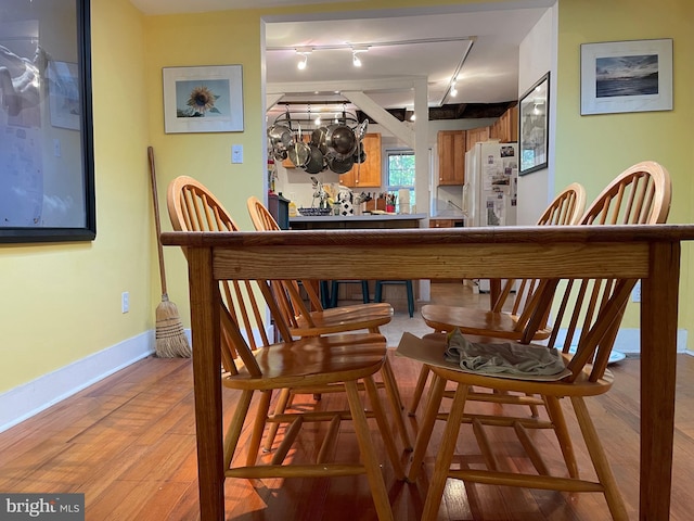 dining room featuring track lighting and light wood-type flooring