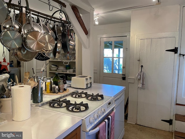 kitchen with stove, light tile flooring, and dishwasher