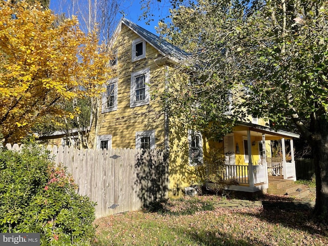 view of side of property featuring a porch