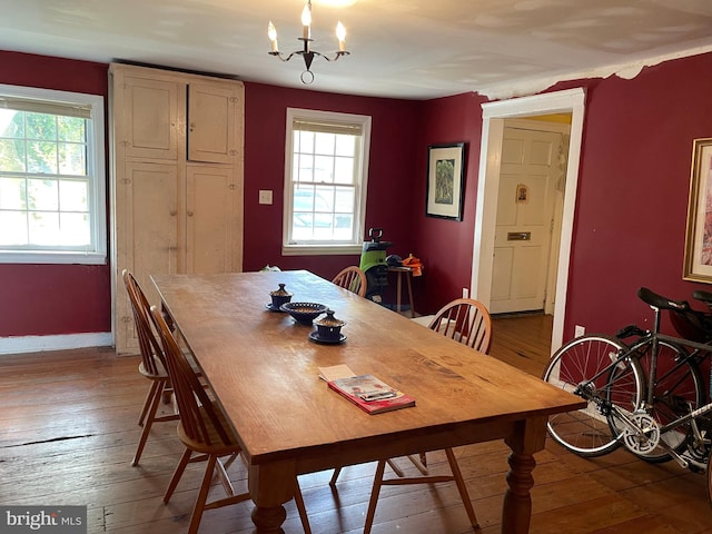 dining room with a chandelier and dark hardwood / wood-style flooring