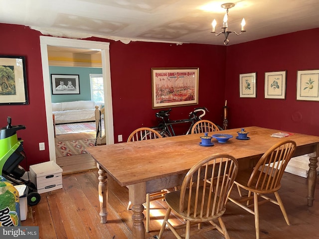 dining room with a chandelier and hardwood / wood-style flooring