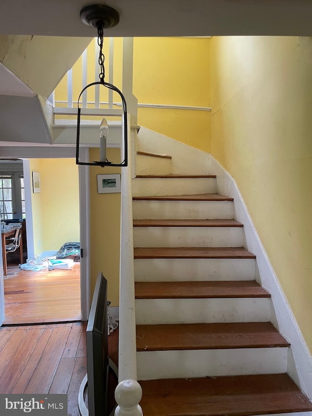 stairs featuring wood-type flooring