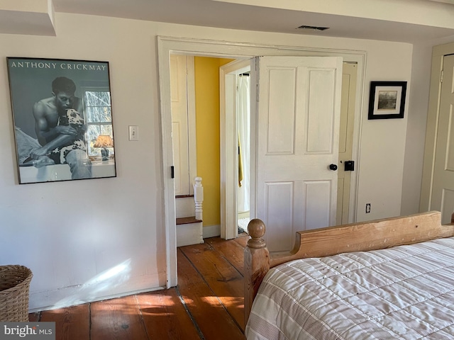 bedroom with dark wood-type flooring