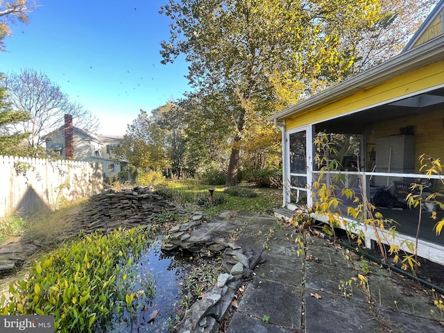 view of yard with a patio and a sunroom