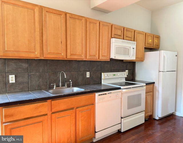 kitchen with dark hardwood / wood-style floors, white appliances, sink, tile counters, and tasteful backsplash